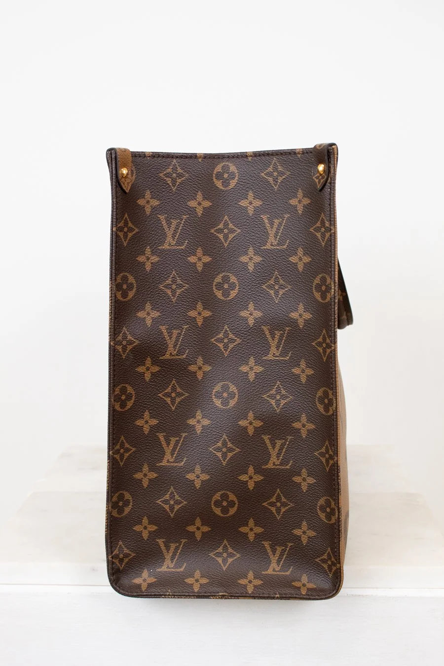 Brown Louis Vuitton monogram bag on a white background