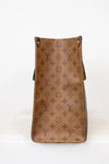Brown leather handbag with monogram pattern on a white background
