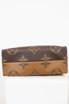 Brown and beige wallet with a pattern on a white background