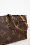 Brown handbag with brand logo pattern on a white background