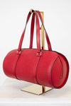 Red handbag with gold accents on a white background