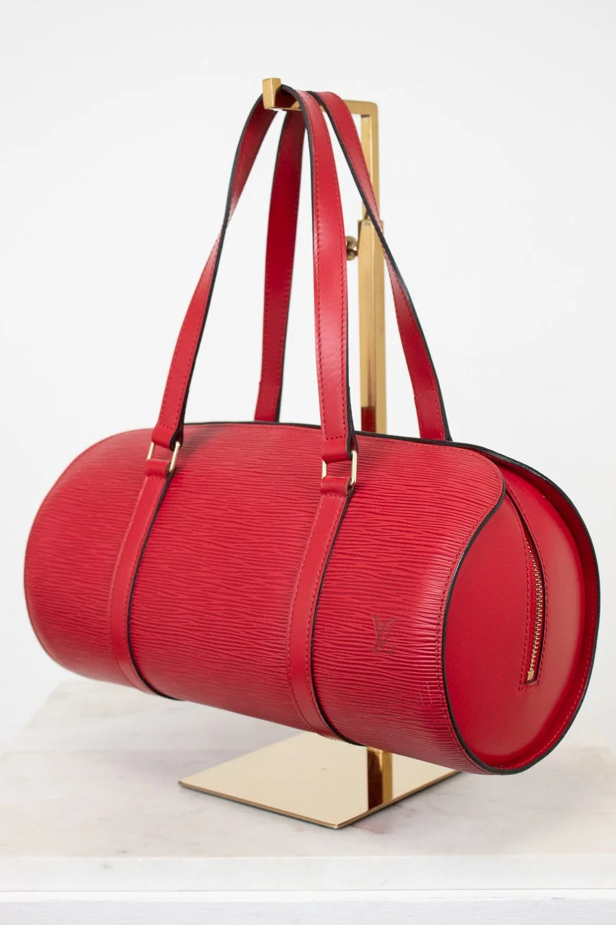 Red handbag with gold accents on a white background