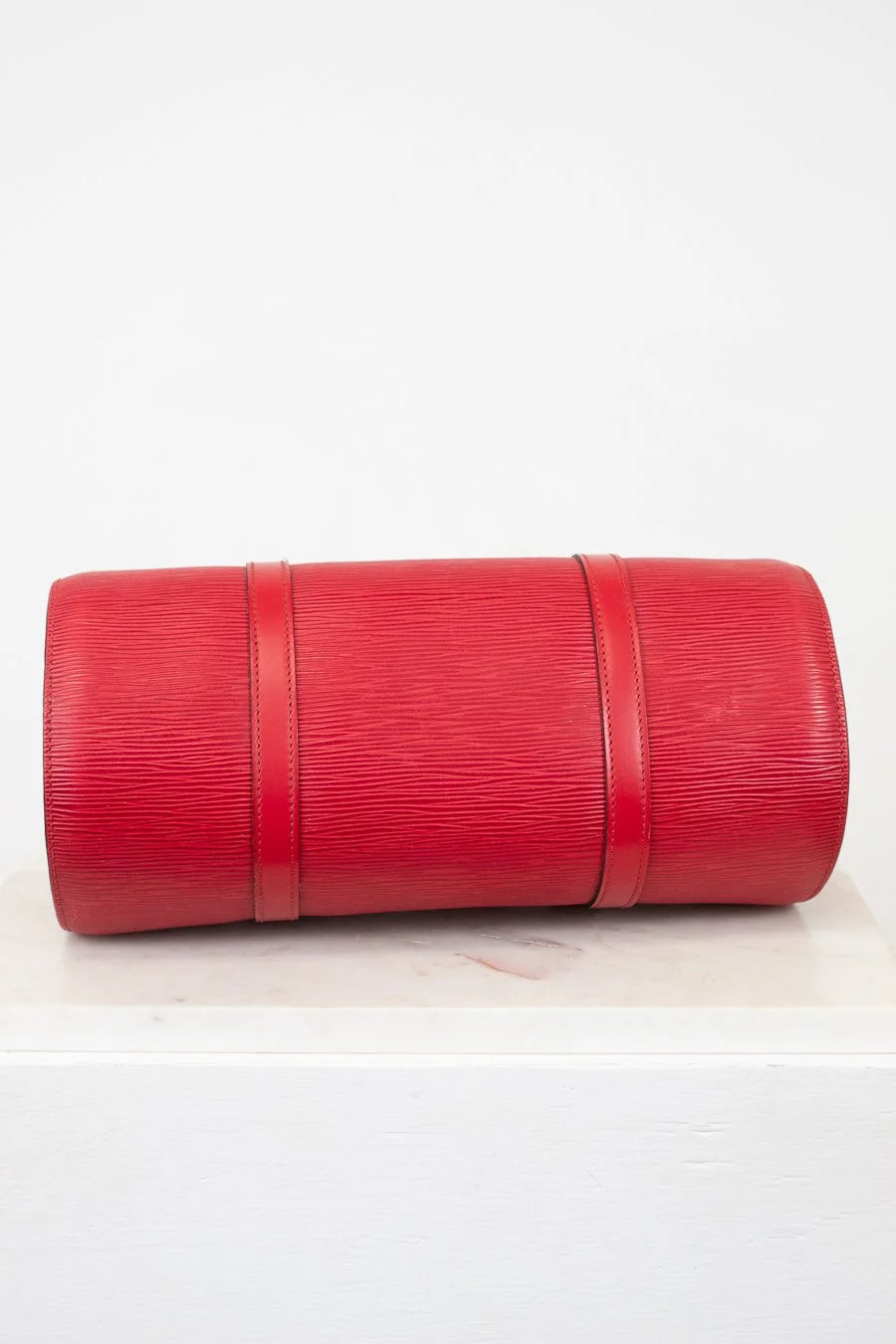 Bottom of Red Epi Leather bag on a white background