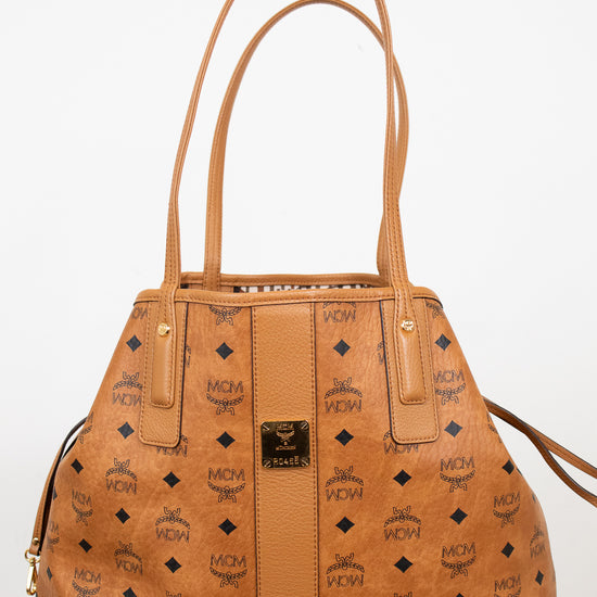 Tan handbag with brand logo on a white background