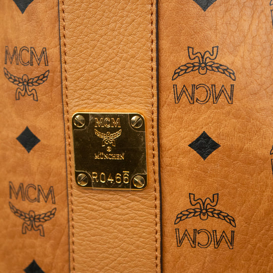 Close-up of a brown leather bag with MCM logo and branding.