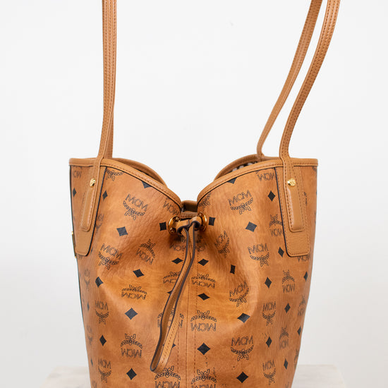 Tan leather handbag with visible brand logo on a white background