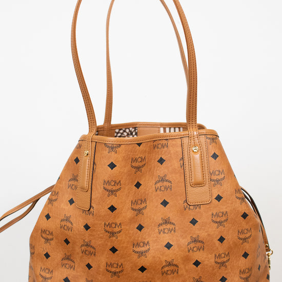 Brown handbag with a visible brand logo on a white background