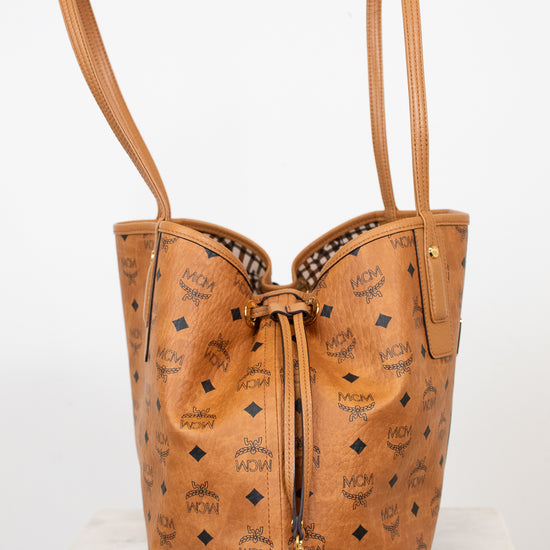 Brown leather handbag with visible brand logo on a white background