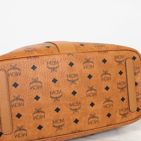 Brown leather bag with black pattern on a white background