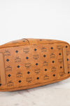 Brown leather bag with black pattern on a white background