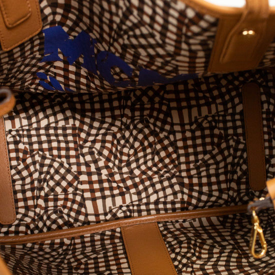 Close-up of a patterned handbag with visible brand name.