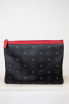 Black textured pouch with a red zipper on a white background