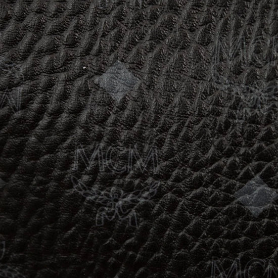 Close-up of a textured black fabric with brand logo