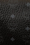 Close-up of a textured black fabric with brand logo