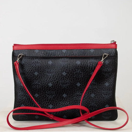 Black textured handbag with red accents on a white background