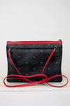 Black textured handbag with red accents on a white background