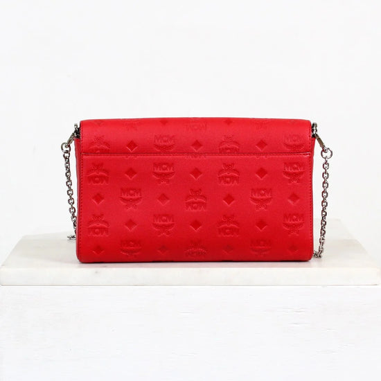 Red handbag with a chain strap on a white background