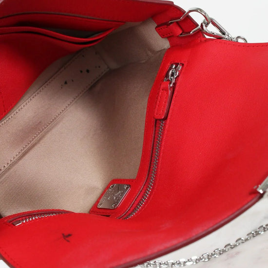 Red handbag with a chain detail on a white background