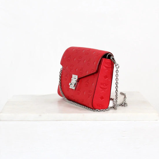 Red handbag with a chain strap on a white background