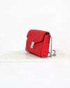 Red handbag with a chain strap on a white background