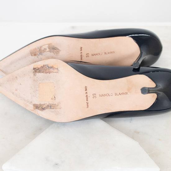 Navy shoes with light tan leather soles on a white background