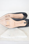 Navy shoes with light tan leather soles on a white background