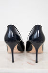 Pair of navy high-heeled shoes on a light background