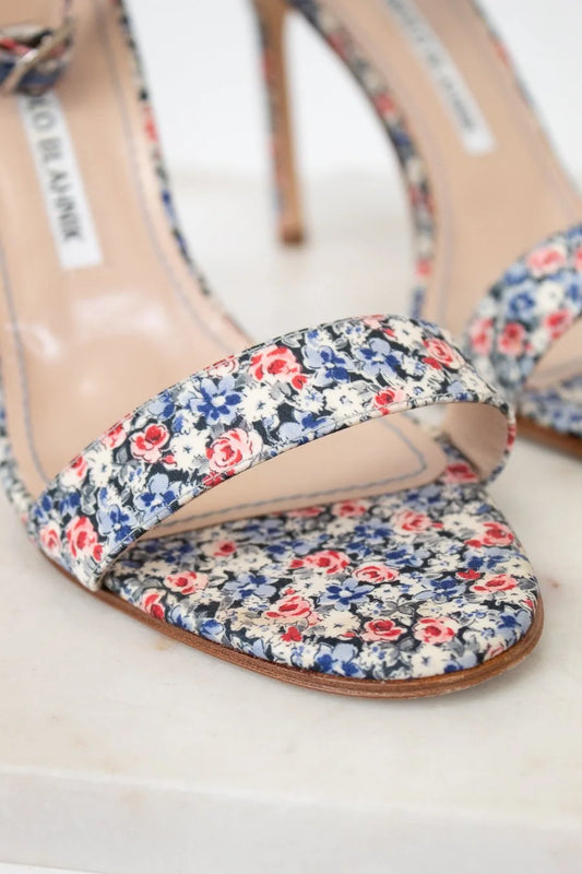 Floral print sandal with 'Manolo Blahnik' label on a white background