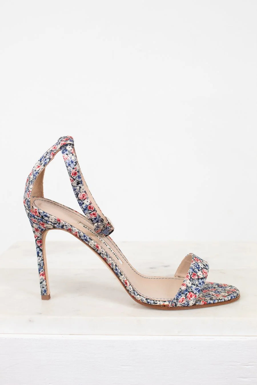 Floral high-heeled sandal on a white background