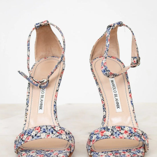 Pair of floral sandals on a white background