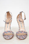 Pair of floral sandals on a white background