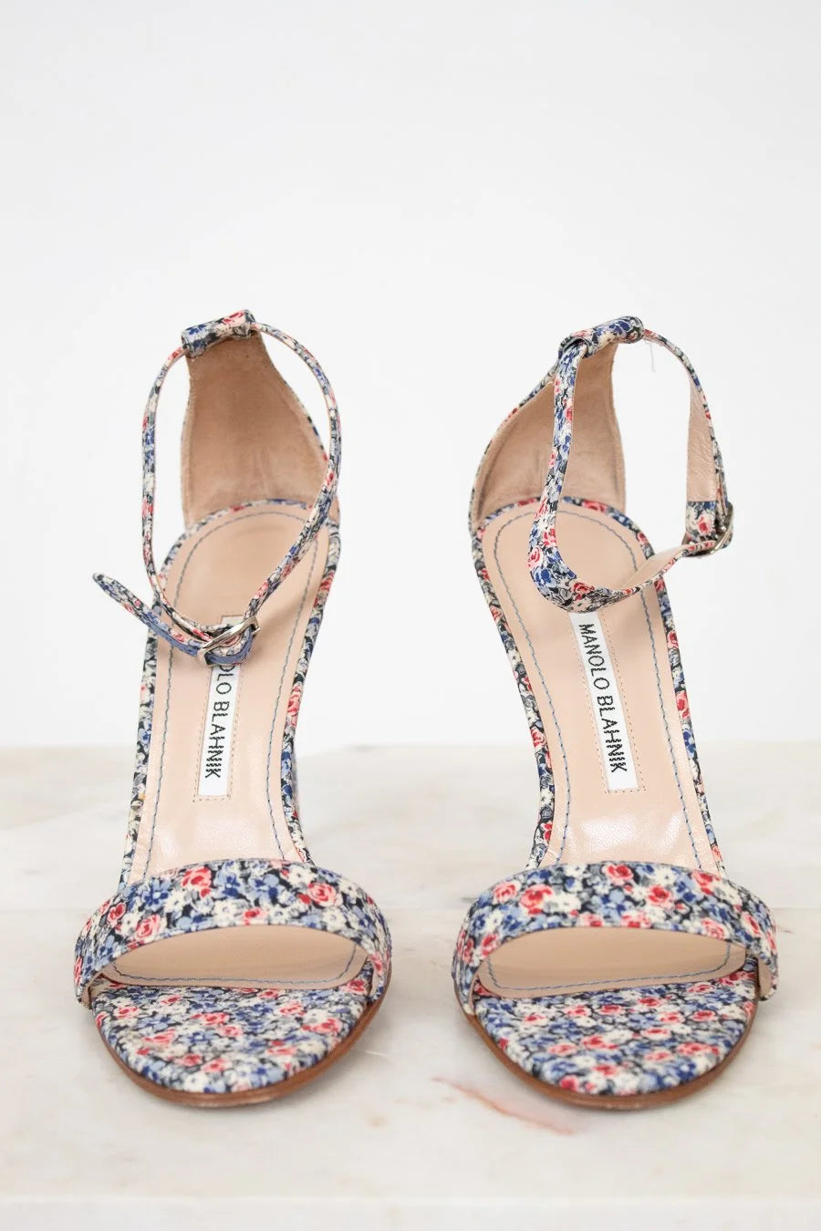 Pair of floral sandals on a white background
