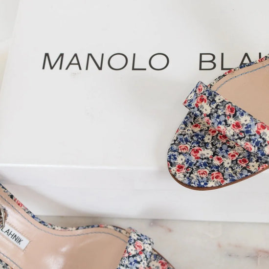 Floral shoes on a Manolo Blahnik box with a white background