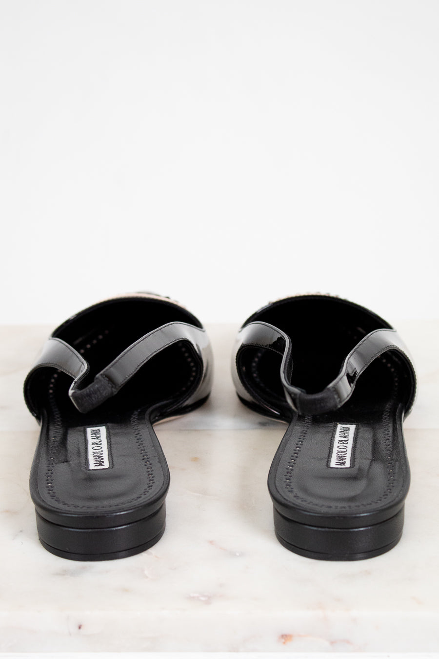 Pair of black sandals on a white background