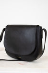 Black leather handbag on a light background