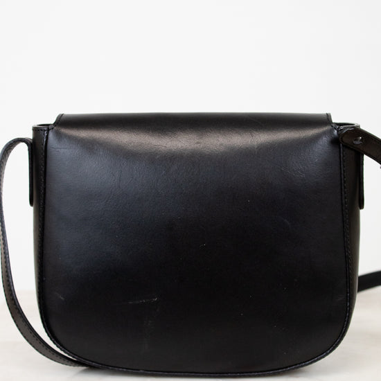 Black leather saddle bag on a white background