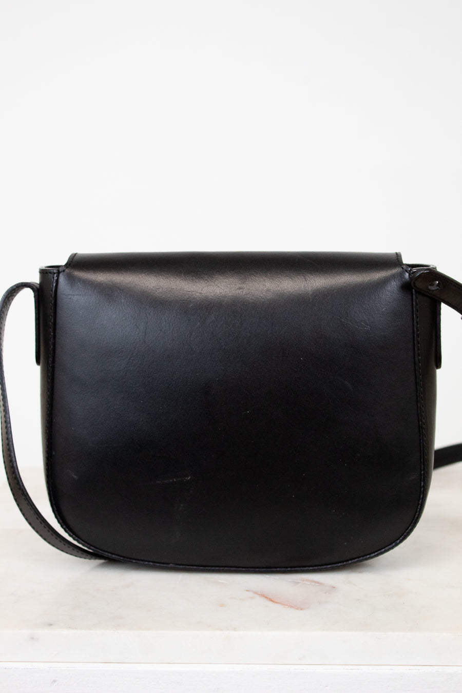 Black leather saddle bag on a white background