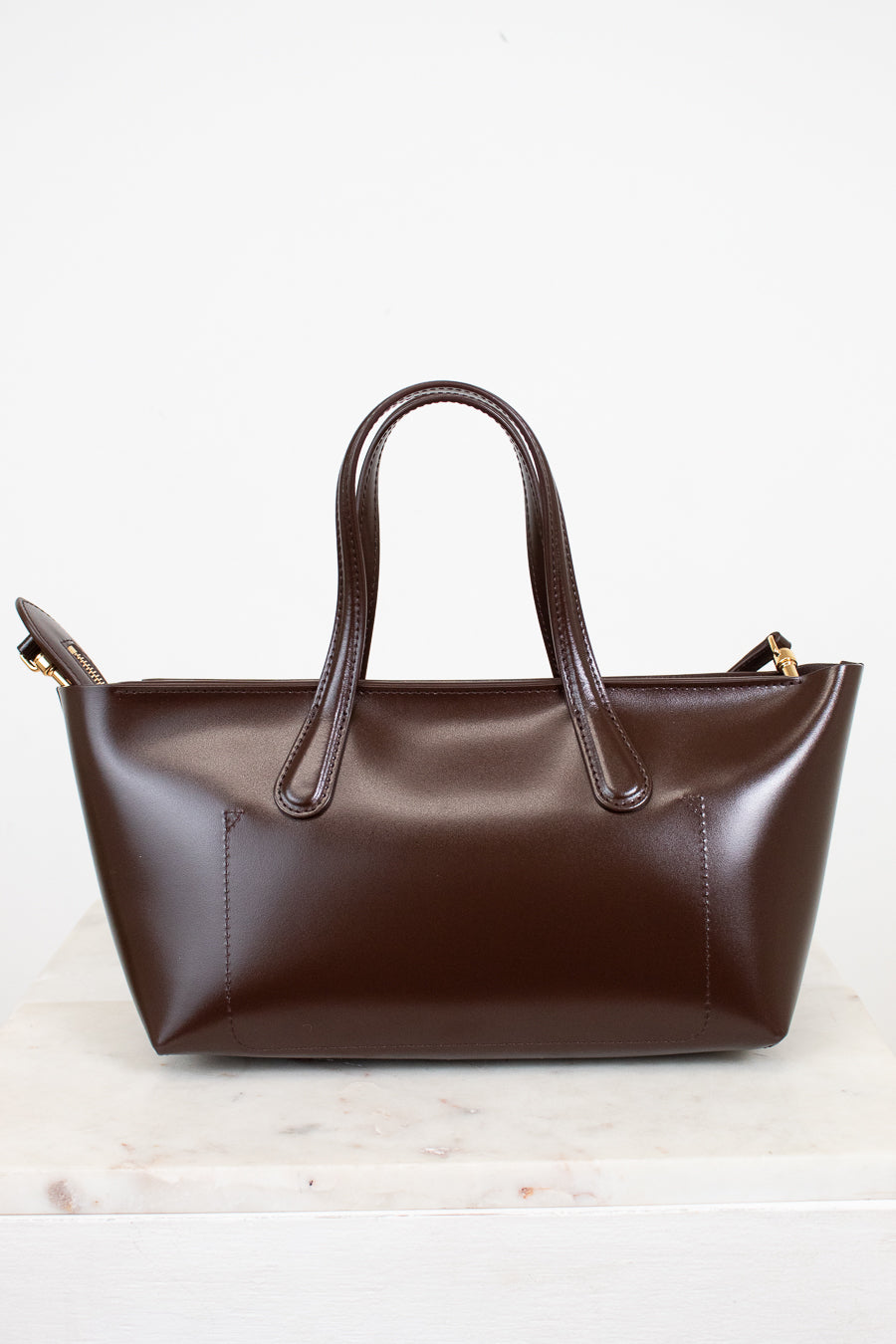 Brown leather handbag on a white background