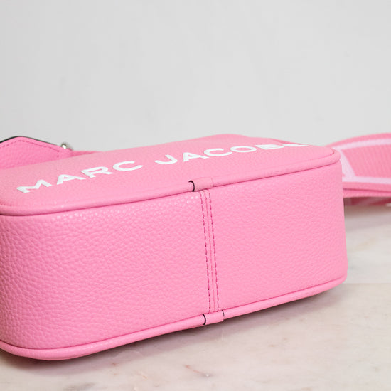 Pink Marc Jacobs bag on a marble surface