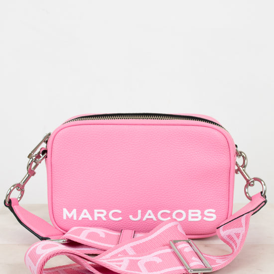 Pink handbag with 'Marc Jacobs' logo on a light background