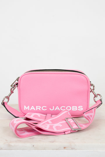 Pink handbag with 'Marc Jacobs' logo on a light background