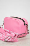 Pink handbag with visible 'Marc Jacobs' branding on a light background