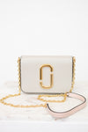 White handbag with gold chain and logo on a white background