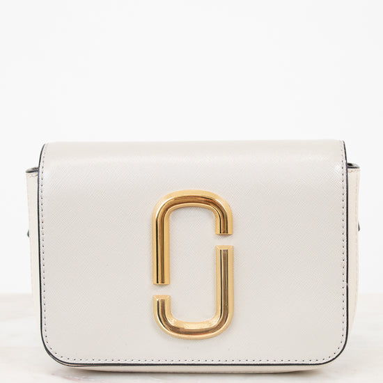 White handbag with gold clasp on a white background