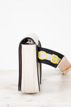 White purse with a black strap featuring yellow and gray accents on a white background