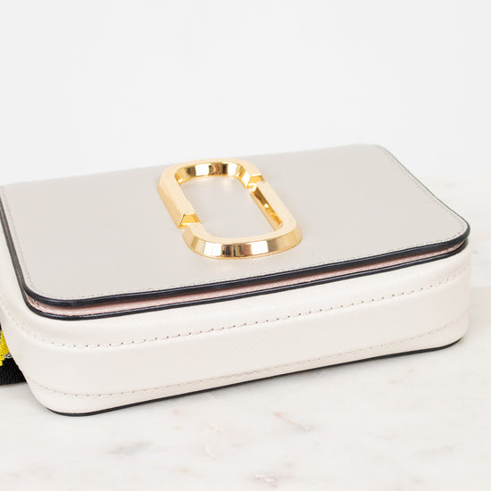 White handbag with gold clasp on a light background