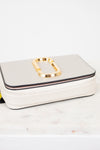 White handbag with gold clasp on a light background