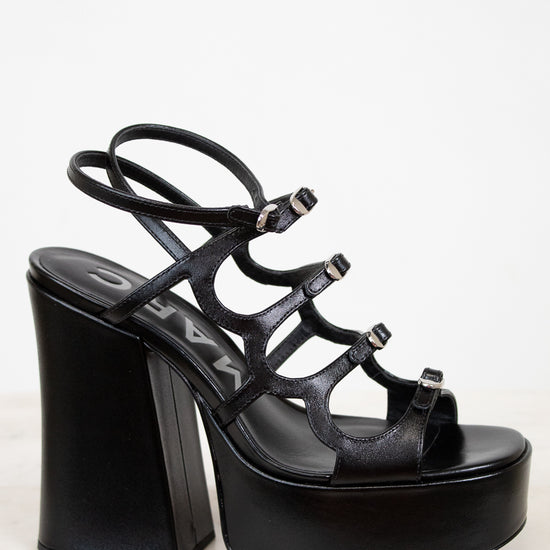 Black platform sandal with high heel on a white background