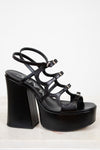 Black platform sandal with high heel on a white background
