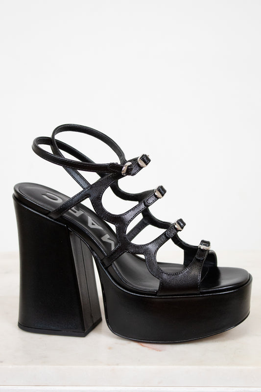 Black platform sandal with high heel on a white background